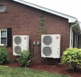 An air conditioning unit mounted to the ouside of a building