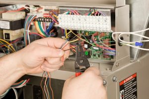 HVAC-installer-strips-small-wiring