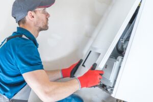 technician-opening-a-furnace-to-perform-repairs