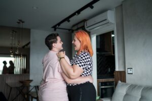 young-couple-dancing-with-ductless-mini-split-air-handler-in-background