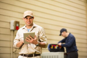 AC-technicians-working-on-an-outdoor-AC-unit