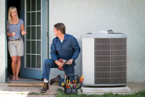 technician-performing-AC-repair-and-answering-the-homeowner's-questions