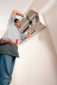 HVAC-tech-working-on-a-mini-split-air-handler